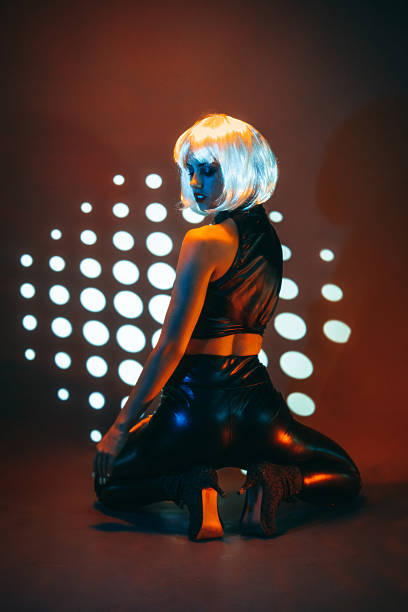 istock Young Woman With A Wig Posing Against Neon Lights 2245970193