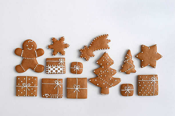 Decorated Christmas gingerbread cookies of various shapes, white background, copy space for text