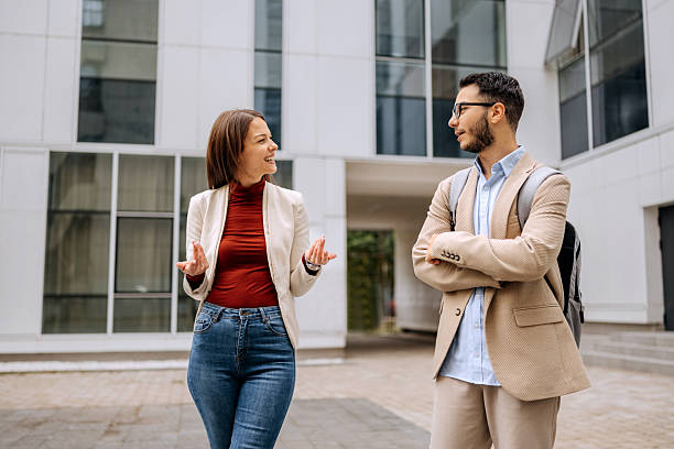 istock Two colleagues walking and talking outdoors 2245972961