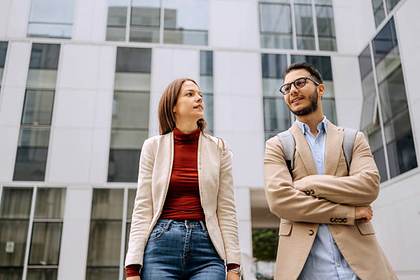 istock Two colleagues walking and talking outdoors 2245972969