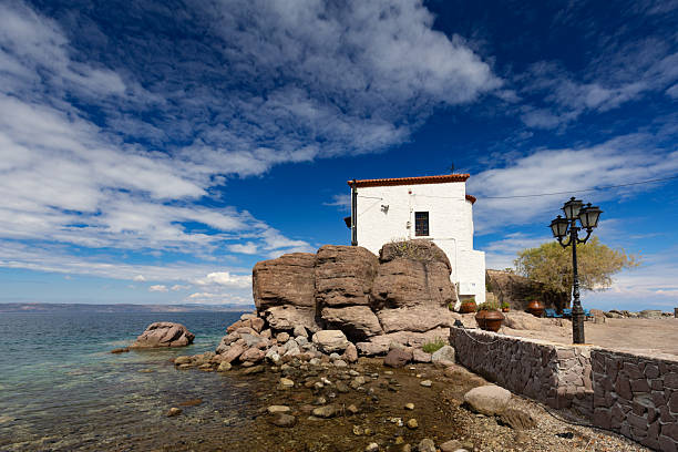 Picturesque seaside landscape with a chapel on a rock, on the Greek volcanic island of Lesbos, background or wallpaper from the project