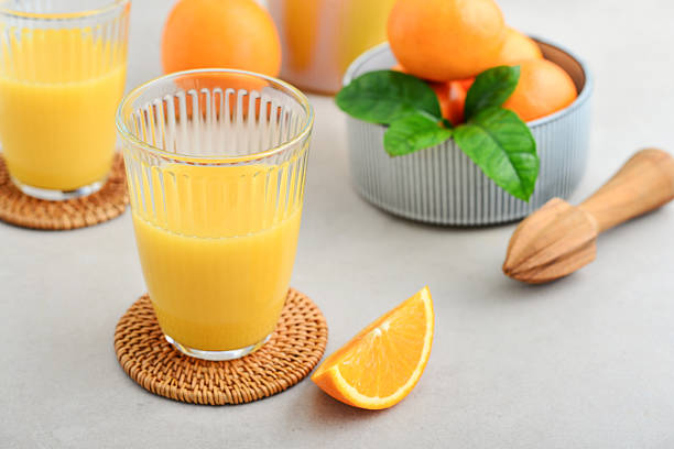 istock Orange fresh squeezed juice in glass and glasses jug 2245973505