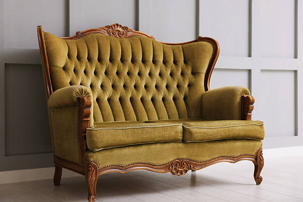istock Stylish sofa near gray wall in room 2245975440
