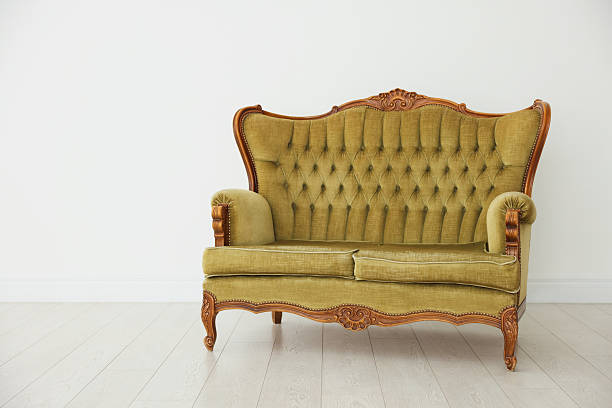 istock Stylish sofa near white wall in room 2245975581