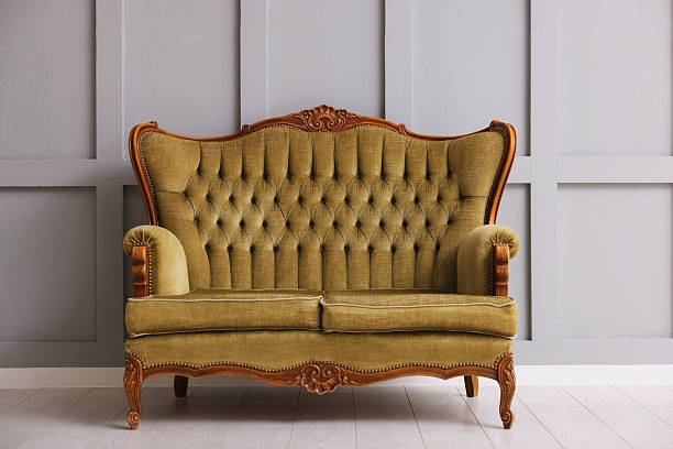 istock Stylish sofa near gray wall in room 2245975602
