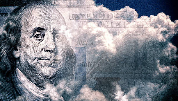 istock American One Hundred dollar in storm clouds, Making money concept 2245977702