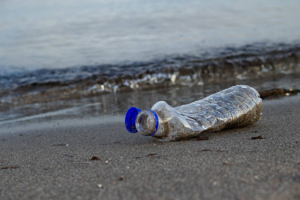 istock Close-up of a plastic bottle washed up on the beach, plastic pollution 2245977812