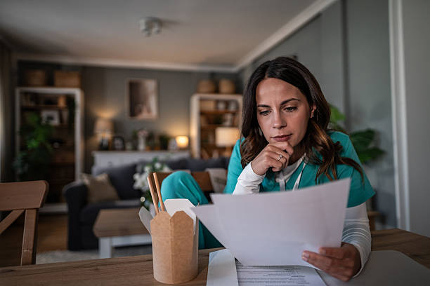 istock Female healthcare worker studying documents at home 2245980744