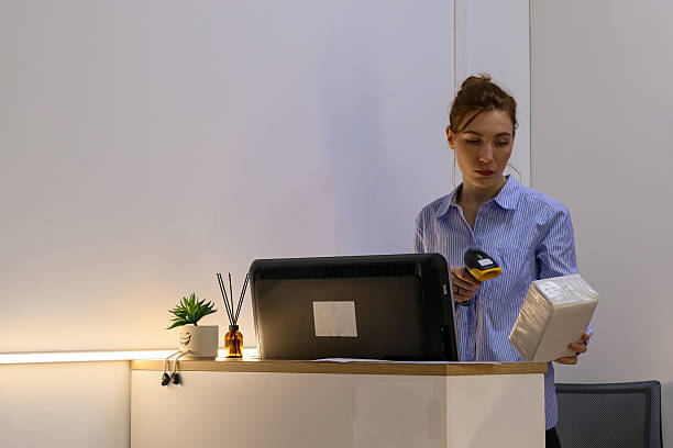 istock Woman scanning wrapped package at pickup desk 2245981541