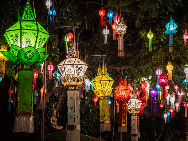 istock Vibrant traditional Lanna lanterns illuminate the night, showcasing intricate patterns during a cultural festival in Chiang Mai, Thailand. A serene Buddha statue rests amidst the glowing spectacle. 2245981782