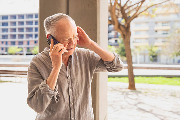 istock Senior man talking on smartphone outdoors in city 2245984676