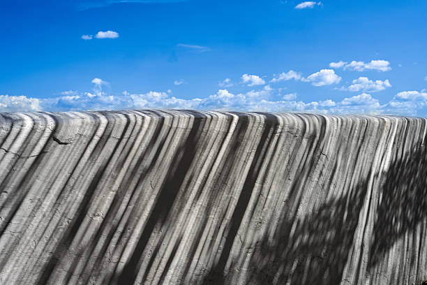 Sunlight creates a beautiful cane mesh shadow on a whitewashed wall in Mertola, Portugal, highlighting the town's serene atmosphere and unique textures.
