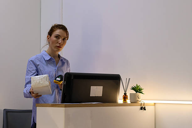 istock Woman holding scanner and package at service counter 2245985431