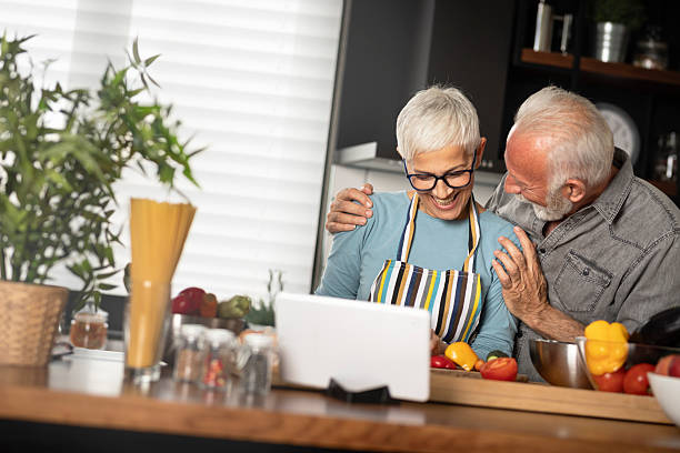 istock Happy senior couple in kitchen. 2245986047