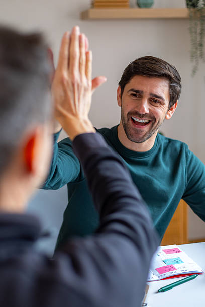 istock Happy colleague celebrating success with high five 2245986869