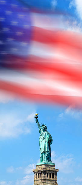 istock Statue of Liberty with American flag 2245987000