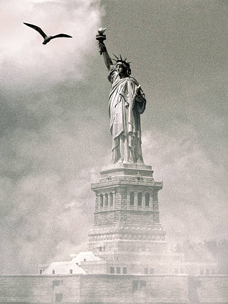 istock Dramatic Statue of Liberty with flying bird over sky 2245987347