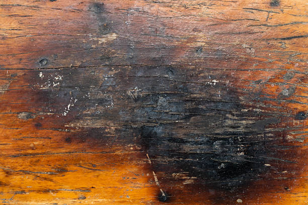 istock Brown wooden background with the scratch and black burning part 2245987453