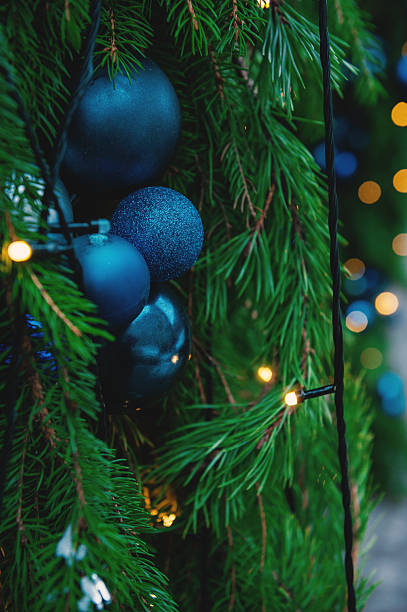 istock Festive pine tree decoration captured with a cozy, bokeh-filled Christmas background 2245988230