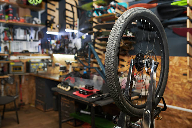 istock Bicycle Wheel Being Repaired in Workshop with Tools and Equipment Visible 2245989604