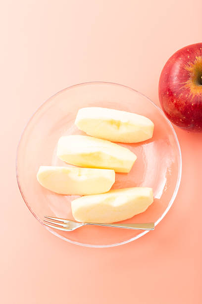 istock Apples in a glass bowl on a pink background 2245989860