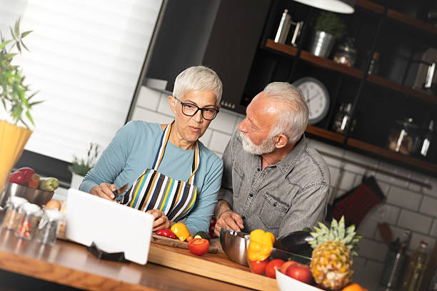 istock Elderly couple and cooking in kitchen with tablet 2245989964