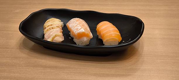 istock Sushi on a black plate Japanese food 2245990770