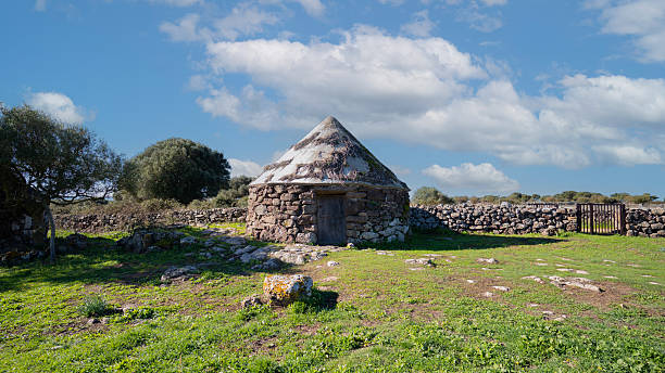 Nuraghe Arrubiu ancient megalithic wall and entrance in bright sunlight