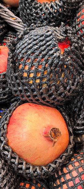 istock Red pomegranates in a fruit shop 2245991284