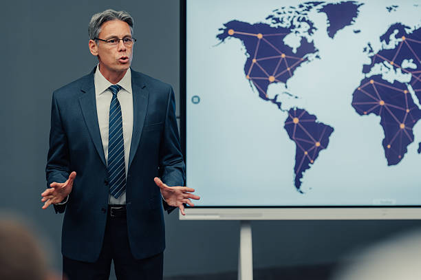 istock Businessman presenting global network strategy with world map 2245991757