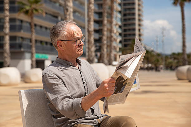 istock Senior man focused on newspaper 2245991959