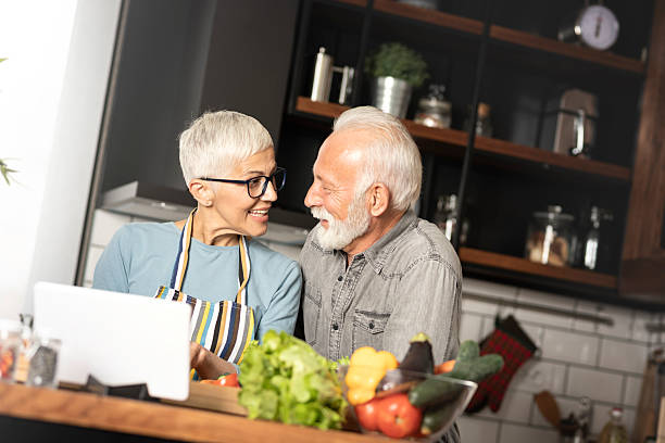 istock Senior couple in modern kitchen preparing lunch 2245992193