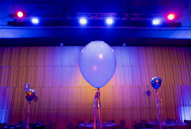 istock Focus on elegant blue balloon surrounded by soft lighting in banquet space, artistic composition of festive decoration, color harmony and modern party celebration style 2245992540