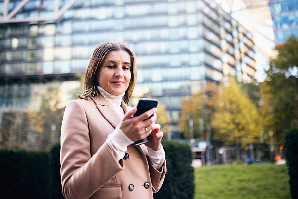 istock Young Businesswoman Walking While Checking Her Smartphone in Berlin in Autumn 2245993312