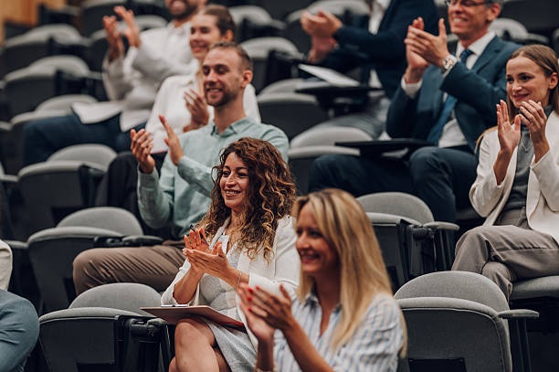 istock Audience members clapping at business conference seminar 2245993422