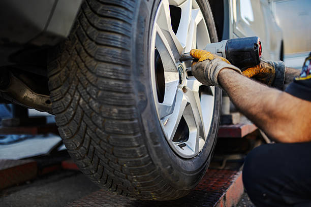 istock Mechanic changing car tire using impact wrench 2245994507