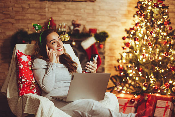 istock Woman is using a laptop and a mobile phone during the Christmas holidays 2245995604