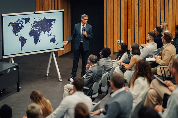 istock Speaker presenting global business strategy with world map 2245995758