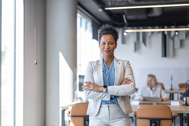 istock Empowered Woman with Crossed Arms in Bright Office 2245995893