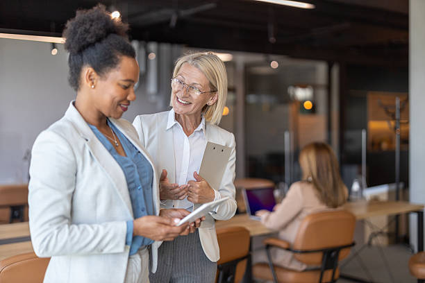 istock Cheerful Businesswomen Sharing Ideas in Office 2245995909