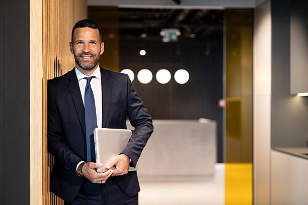 istock Successful Businessman Posing with Laptop at Office 2245996456