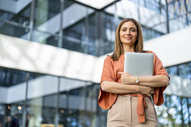 istock Confident Businesswoman with Laptop in Bright Workplace 2245996457