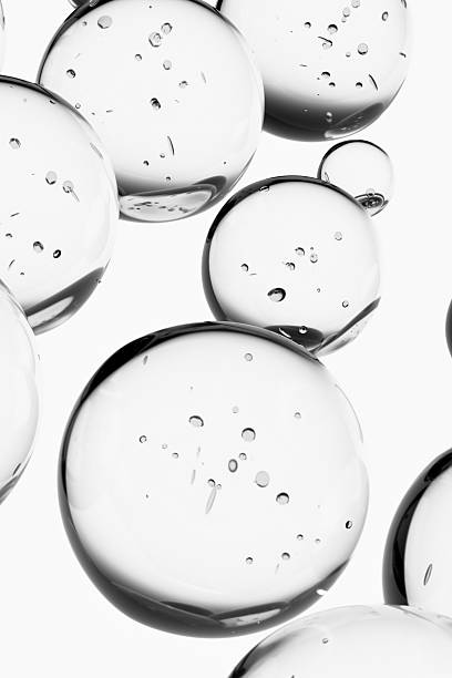 istock Abstract 3d liquid, water drops, molecules with bubbles on gray background. Concept of cosmetics, science, and medicine. Pattern, template for products, designs, place for text. 2245996652