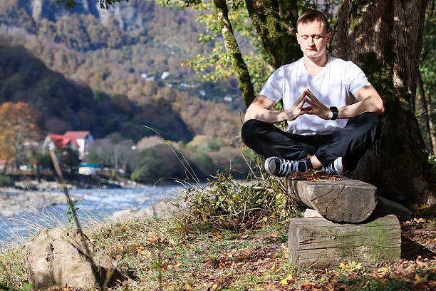 istock Man forming triangle with fingers in meditation pose 2245999953