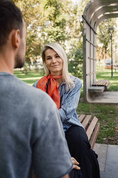 istock Casual outdoor conversation between two people in a park setting 2246000988