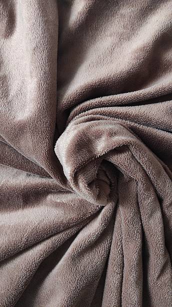 istock Soft Brown Fabric Wrapped in a Circular Pattern on a Cozy Surface Perfect for Relaxation or Decoration 2246001366