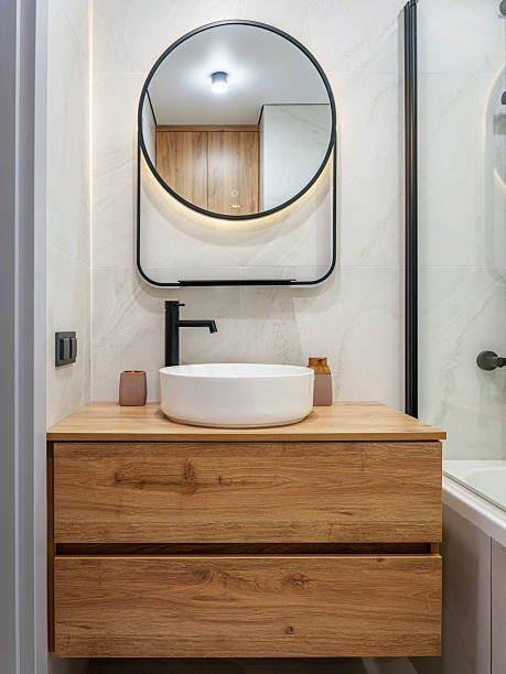 istock Stylish Bathroom with Wood Vanity and Ambient Lighting 2246005077