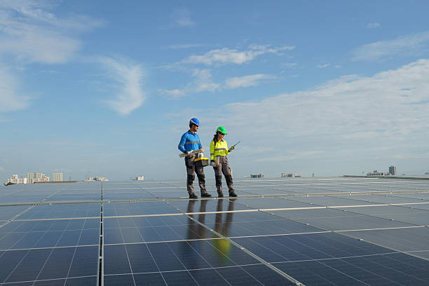 istock Engineers inspect solar panels recently installed on a high-rise building. 2246005078