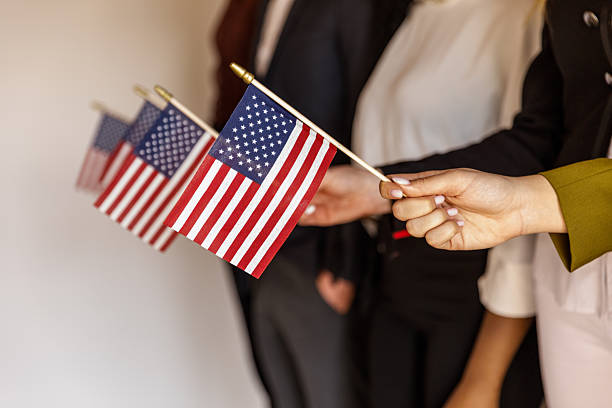 istock Group of people standing in line, holding American flags 2246005471