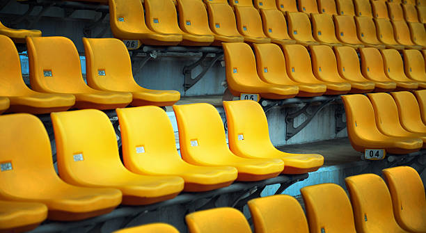 istock Row of empty yellow seats at stadium 2246006719